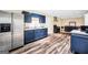 Spacious kitchen featuring luxury vinyl flooring, stainless steel appliances, and dark blue cabinetry at 186 Ashley Dr, Mcdonough, GA 30252