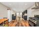 Open eat-in kitchen featuring laminate flooring, dark cabinets, and modern appliances at 186 Ashley Dr, Mcdonough, GA 30252