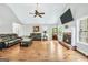Open living room with hardwood floors, vaulted ceiling, and fireplace at 186 Ashley Dr, Mcdonough, GA 30252
