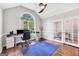 Well-lit home office with hardwood floors, arched window, and neutral paint at 186 Ashley Dr, Mcdonough, GA 30252