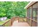 This screened patio has a railing, and is perfect for relaxation and entertainment with a view of the yard at 186 Ashley Dr, Mcdonough, GA 30252