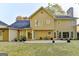 Large backyard with patio, ample grass, and the home's exterior featuring neutral siding and dark roof at 3034 Brookgreen Trl, Lawrenceville, GA 30043