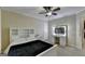 Well-lit bedroom with a bed, vanity table with a lighted mirror, and neutral decor at 3034 Brookgreen Trl, Lawrenceville, GA 30043