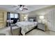 Spacious bedroom with a desk, bed with grey bedding, and neutral decor at 3034 Brookgreen Trl, Lawrenceville, GA 30043