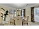 Elegant dining room featuring a round table, tufted chairs, and a decorative chandelier at 3034 Brookgreen Trl, Lawrenceville, GA 30043