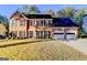 Two-story brick home with a two-car garage, black shutters, and a well-manicured lawn at 3034 Brookgreen Trl, Lawrenceville, GA 30043
