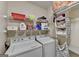 Functional laundry room with washer, dryer, shelving, and storage space at 3034 Brookgreen Trl, Lawrenceville, GA 30043