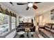 Open-concept living room with leather sofas, a view of the kitchen, and lots of natural light at 3034 Brookgreen Trl, Lawrenceville, GA 30043