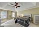 Inviting main bedroom with a tray ceiling, fan, and large windows for natural light at 3034 Brookgreen Trl, Lawrenceville, GA 30043