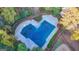 Aerial view of the community pool with a cover, surrounded by lush greenery and landscaping at 3034 Brookgreen Trl, Lawrenceville, GA 30043