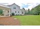 Home exterior with a spacious backyard and a manicured lawn, showcasing the property's outdoor space at 5187 Lower Fayetteville Rd, Sharpsburg, GA 30277