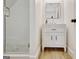 Bathroom with a white vanity, a square mirror, and a glass enclosed shower with modern tiling at 5187 Lower Fayetteville Rd, Sharpsburg, GA 30277