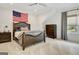 Bedroom with dark wood furniture, neutral carpet, and a large window at 5187 Lower Fayetteville Rd, Sharpsburg, GA 30277
