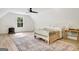 Bright bedroom featuring neutral tones, a wood-look floor, an area rug, and a quaint window at 5187 Lower Fayetteville Rd, Sharpsburg, GA 30277