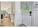 Inviting foyer with paneled walls and a view of the open-concept living spaces creates an airy feel at 5187 Lower Fayetteville Rd, Sharpsburg, GA 30277