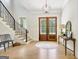 Inviting foyer with beautiful hardwood floors, elegant staircase, and double entry doors at 5187 Lower Fayetteville Rd, Sharpsburg, GA 30277