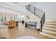 Bright and open foyer with hardwood floors, elegant staircase, and an arched doorway at 5187 Lower Fayetteville Rd, Sharpsburg, GA 30277