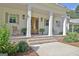 Inviting front porch with brick steps, rocking chairs and wooden double doors at 5187 Lower Fayetteville Rd, Sharpsburg, GA 30277