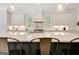 This kitchen boasts a large island with pendant lighting and overlooks a bright, airy space with windows at 5187 Lower Fayetteville Rd, Sharpsburg, GA 30277