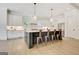 Stylish kitchen featuring a large center island, modern pendant lighting, and stainless appliances at 5187 Lower Fayetteville Rd, Sharpsburg, GA 30277