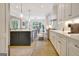 This kitchen features bright white cabinets, a large island, and hardwood floors, making it feel spacious at 5187 Lower Fayetteville Rd, Sharpsburg, GA 30277
