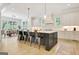 Open kitchen design with a spacious island, seating, and views into the breakfast area at 5187 Lower Fayetteville Rd, Sharpsburg, GA 30277