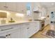 Gourmet kitchen features white cabinets, quartz countertops, and stainless steel appliances at 5187 Lower Fayetteville Rd, Sharpsburg, GA 30277
