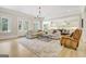 Open-concept living room with hardwood floors and a view into a modern kitchen at 5187 Lower Fayetteville Rd, Sharpsburg, GA 30277