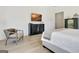 This main bedroom features a soothing palette, hardwood floors, and a view of a dresser with a television at 5187 Lower Fayetteville Rd, Sharpsburg, GA 30277