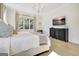 Elegant main bedroom showcases hardwood floors, a large window, and a stylish dresser, creating a cozy space at 5187 Lower Fayetteville Rd, Sharpsburg, GA 30277