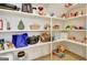 Well-stocked pantry with multiple shelves and hardwood floors is perfect for easy organization and storage at 5187 Lower Fayetteville Rd, Sharpsburg, GA 30277