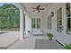 Charming covered porch with a swing, ceiling fan, and stylish accents, offering a cozy outdoor space at 5187 Lower Fayetteville Rd, Sharpsburg, GA 30277