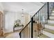 Open staircase with metal railing leads to a cozy living space at 5187 Lower Fayetteville Rd, Sharpsburg, GA 30277