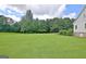 View of the expansive yard with lush lawn and attractive landscaping at 5187 Lower Fayetteville Rd, Sharpsburg, GA 30277