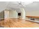 Large bonus room featuring wood flooring, built-in shelves, and ceiling fans at 324 Chimney Sweep Cir, Peachtree City, GA 30269