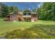 Large backyard featuring a brick home with screened-in porch and back porch at 1041 Flat Rock Rd, Covington, GA 30014