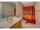 Bathroom with shower, tiled floor, and single sink at 1041 Flat Rock Rd, Covington, GA 30014