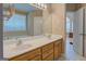 Bathroom vanity with double sinks, large mirror, and wooden cabinets in a neutral toned room at 1041 Flat Rock Rd, Covington, GA 30014