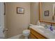 Bathroom with a single sink, toilet, light-colored walls and decor at 1041 Flat Rock Rd, Covington, GA 30014