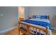 Bedroom with hardwood floors, light-colored walls, and a view into bathroom at 1041 Flat Rock Rd, Covington, GA 30014