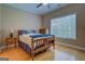 This bedroom has a window with a wood frame bed, wood floor and ceiling fan at 1041 Flat Rock Rd, Covington, GA 30014