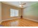 Bedroom with hardwood floors, light-colored walls, ceiling fan, and window at 1041 Flat Rock Rd, Covington, GA 30014
