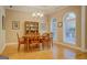 Dining area with hardwood floors and natural light from arched windows at 1041 Flat Rock Rd, Covington, GA 30014