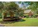 Charming brick home featuring a well-manicured lawn, mature landscaping, and traditional design elements at 1041 Flat Rock Rd, Covington, GA 30014
