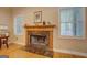 Cozy living room fireplace with marble surround and elegant wood mantle at 1041 Flat Rock Rd, Covington, GA 30014