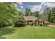 Charming front exterior of a single-story brick home with a well-manicured lawn and mature landscaping at 1041 Flat Rock Rd, Covington, GA 30014
