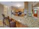 Kitchen with a large granite countertop, stainless steel appliances, and wooden cabinets at 1041 Flat Rock Rd, Covington, GA 30014