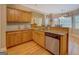 Kitchen with stainless steel dishwasher and wooden cabinets and granite countertops at 1041 Flat Rock Rd, Covington, GA 30014