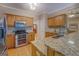 Open kitchen layout with granite countertops, stainless appliances and wood cabinets at 1041 Flat Rock Rd, Covington, GA 30014