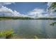 Picturesque lake view offers serene water, distant shoreline, and clear sky with scattered clouds at 1041 Flat Rock Rd, Covington, GA 30014